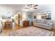 Inviting living room featuring a plush sofa, decorative rug, and adjacent dining area at 2500 Lee Rd # 243, Winter Park, FL 32789