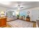 Cozy living room with neutral tones, ceiling fan, large rug and comfortable furniture at 2500 Lee Rd # 243, Winter Park, FL 32789