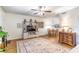 Comfortable living room with stylish decor, modern TV console, and a view into the dining area at 2500 Lee Rd # 243, Winter Park, FL 32789