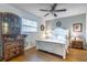 Comfortable main bedroom features a ceiling fan, window, and furniture at 2500 Lee Rd # 243, Winter Park, FL 32789