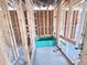 Unfinished bathroom with exposed framing and tub at 30166 Rustic Mill Street, Mount Dora, FL 32757
