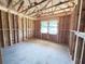 Unfinished bedroom with exposed framing, and two windows at 30166 Rustic Mill Street, Mount Dora, FL 32757