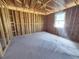 Unfinished bedroom with exposed framing and window at 30166 Rustic Mill Street, Mount Dora, FL 32757