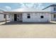 Rear exterior view of the new home featuring a covered patio, windows, and construction materials in place at 30166 Rustic Mill Street, Mount Dora, FL 32757