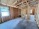 Unfinished living room with exposed framing and window at 30166 Rustic Mill Street, Mount Dora, FL 32757