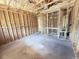 Unfinished living room with exposed framing and concrete floor at 30166 Rustic Mill Street, Mount Dora, FL 32757
