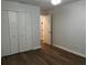 Comfortable bedroom with hardwood-style floors, closet, and neutral wall color at 3120 Plaza Terrace Dr # 3120, Orlando, FL 32803