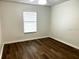 A sunlit bedroom with wood flooring and a large window, providing natural light at 3120 Plaza Terrace Dr # 3120, Orlando, FL 32803