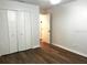 Bedroom featuring wood flooring, a closet with sliding doors, and neutral paint at 3120 Plaza Terrace Dr # 3120, Orlando, FL 32803