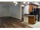 Bright living room with modern light fixture, wood floors, and adjacent kitchen at 3120 Plaza Terrace Dr # 3120, Orlando, FL 32803