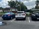 View of reserved parking spaces in a well-maintained parking lot with multiple cars at 3120 Plaza Terrace Dr # 3120, Orlando, FL 32803