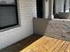 Covered patio with painted brick and wooden flooring, offering a cozy outdoor space at 3120 Plaza Terrace Dr # 3120, Orlando, FL 32803