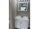 Bathroom vanity featuring a white sink, cabinet storage, and a framed mirror with vanity lights at 3187 Shady Willow Dr, Orlando, FL 32808