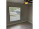 Bedroom featuring wood-look floors, a ceiling fan, and a window offering exterior views at 3187 Shady Willow Dr, Orlando, FL 32808