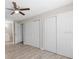 Spacious bedroom featuring a ceiling fan, wood-look flooring, and ample closet space at 3187 Shady Willow Dr, Orlando, FL 32808