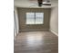 Bright bedroom featuring wood-look flooring, a ceiling fan, and a window for natural light at 3187 Shady Willow Dr, Orlando, FL 32808