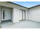 Covered entrance patio with modern door and sliding glass door, offering an inviting outdoor space at 3187 Shady Willow Dr, Orlando, FL 32808