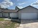 Charming single-story home with an attached two-car garage and well-maintained landscaping at 3187 Shady Willow Dr, Orlando, FL 32808