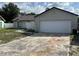 View of the home's exterior showcasing the two car garage and well-maintained lawn at 3187 Shady Willow Dr, Orlando, FL 32808