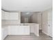 Bright kitchen featuring white cabinets, a stainless steel sink, and new floors, ideal for cooking at 3187 Shady Willow Dr, Orlando, FL 32808