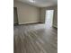Open-concept living area with lots of natural light and modern gray floors at 3187 Shady Willow Dr, Orlando, FL 32808