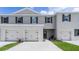 Charming townhome featuring a two-car garage and neutral-toned exterior with decorative shutters at 3298 Wye Oak Dr, Apopka, FL 32703