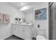 Modern bathroom featuring double sinks, a large mirror, a toilet, and a tiled shower at 3345 Thicket St, Tavares, FL 32778