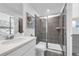 Contemporary bathroom with a glass shower, grey tiles, white cabinets and modern fixtures at 3345 Thicket St, Tavares, FL 32778