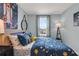 This bedroom boasts a space-themed comforter and wall art, complemented by a window offering natural light at 3345 Thicket St, Tavares, FL 32778