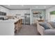 Open-concept kitchen with an island, stainless steel appliances, and seamless flow into the living room at 3345 Thicket St, Tavares, FL 32778
