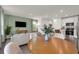 Bright open-concept living room and kitchen, with modern decor, wood floors, and a green accent wall at 3345 Thicket St, Tavares, FL 32778