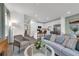 Open-concept living area with modern furnishings, connecting seamlessly to a stylish kitchen, creating a bright and inviting space at 3345 Thicket St, Tavares, FL 32778