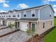 Desirable end unit townhome with blue siding, manicured lawn, and lush green landscaping at 3348 Thicket St, Tavares, FL 32778