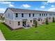 Exterior shot showing a row of townhomes with well-maintained lawns and landscaping at 3348 Thicket St, Tavares, FL 32778