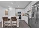 Modern kitchen featuring stainless steel appliances, white cabinets, and an island with bar stools at 3348 Thicket St, Tavares, FL 32778