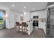 Open-concept kitchen with island seating, stainless steel appliances and white cabinetry at 3348 Thicket St, Tavares, FL 32778