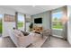 Inviting living room featuring a neutral color palette, stylish curtains, and ample natural light at 3348 Thicket St, Tavares, FL 32778
