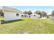 Exterior shot of the property showcasing the large backyard, additional storage buildings, and fenced perimeter at 338 Eastern Ave, St Cloud, FL 34769