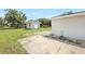 Exterior shot of the backyard featuring a shed, lawn, gravel and concrete patio at 338 Eastern Ave, St Cloud, FL 34769