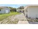 Exterior shot of the property showing the fenced yard, well-maintained lawn, and exterior of the house at 338 Eastern Ave, St Cloud, FL 34769