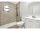 Modern bathroom featuring gray tiled shower with a rain shower head and updated white vanity at 338 Eastern Ave, St Cloud, FL 34769