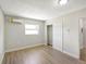 Bedroom featuring sleek floors, neutral paint, a window, mini-split AC, and a closet with sliding doors at 338 Eastern Ave, St Cloud, FL 34769