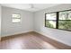 Light-filled bedroom with two windows and neutral color palette at 338 Eastern Ave, St Cloud, FL 34769