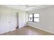 Bedroom featuring wood-look floors and a closet with sliding doors at 338 Eastern Ave, St Cloud, FL 34769