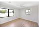 Bright bedroom with wood-look floors features two windows offering ample natural light at 338 Eastern Ave, St Cloud, FL 34769