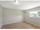 Bright bedroom featuring sleek wood floors, neutral paint, a window, and a modern mini-split AC system at 338 Eastern Ave, St Cloud, FL 34769