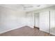 Spacious bedroom featuring wood-look floors, closet, and ceiling fan at 338 Eastern Ave, St Cloud, FL 34769