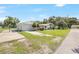 View of a house with detached garage, a fenced yard, and an expansive driveway at 338 Eastern Ave, St Cloud, FL 34769