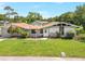 Charming single-story home featuring a well-manicured lawn and mature landscaping at 338 Eastern Ave, St Cloud, FL 34769