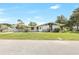 Charming home exterior featuring a well-manicured lawn, mature trees, and a welcoming front entrance at 338 Eastern Ave, St Cloud, FL 34769